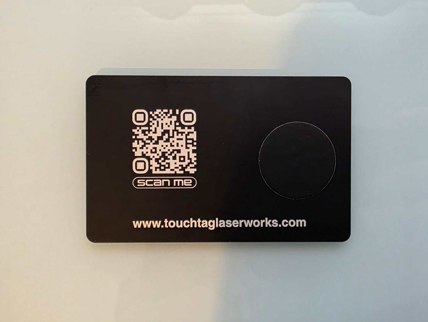 Black card with QR code and text on a light gray background